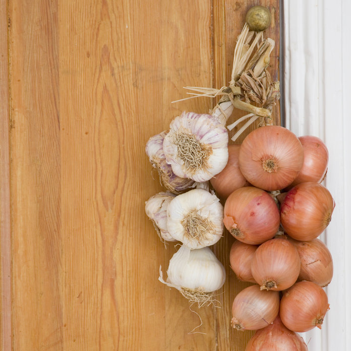 Onions and garlic hanging on the door